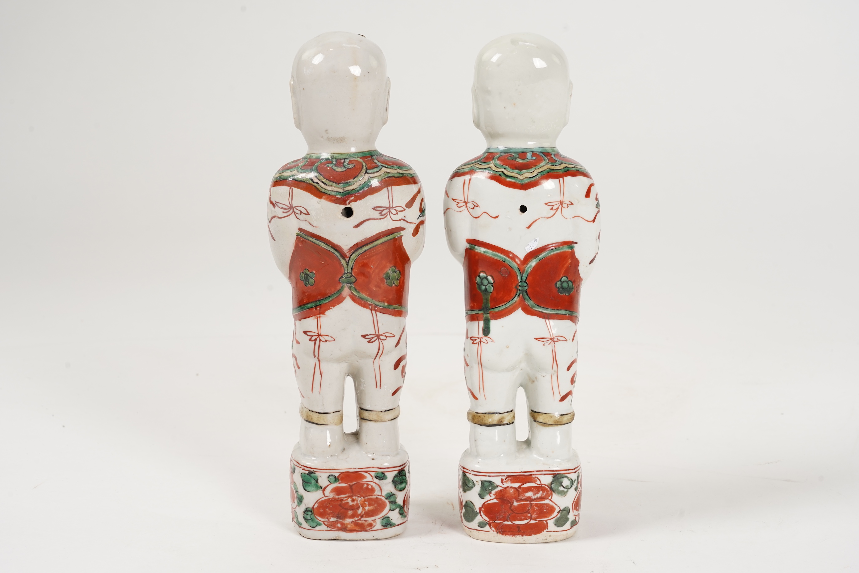 A pair of Chinese famille verte figures of smiling boys, Kangxi period